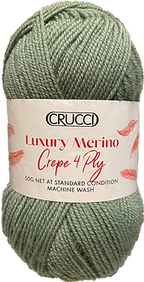 A skein of Crucci luxury merino crepe yarn in a green color, with packaging that includes the brand name and yarn details.