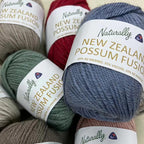 Balls of yarn in various colours with 'Naturally New Zealand Possum Fusion' labels 