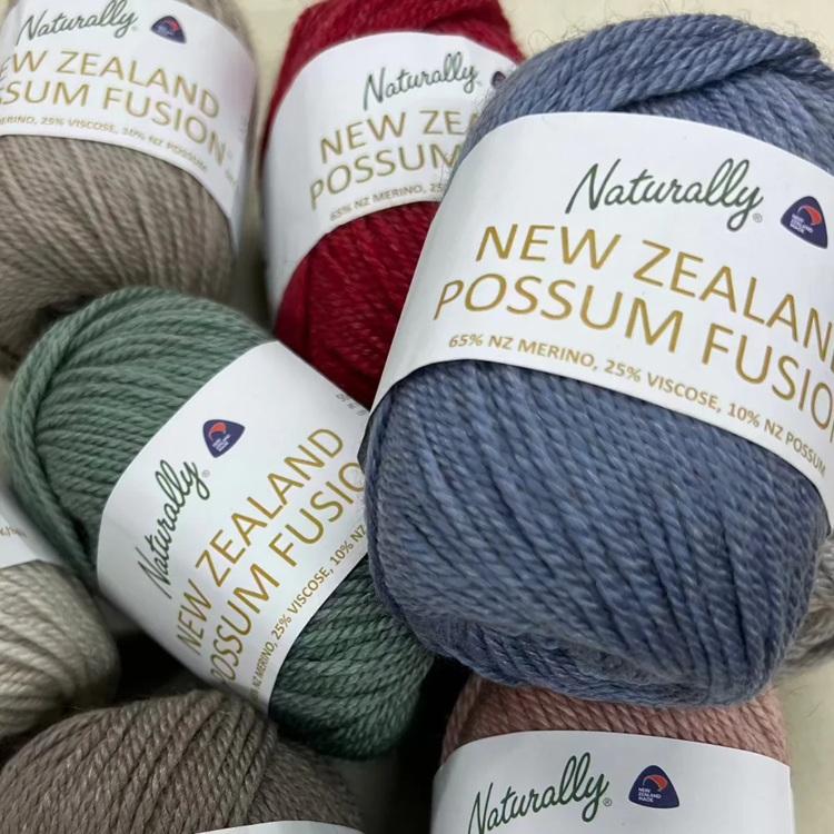 Balls of yarn in various colours with 'Naturally New Zealand Possum Fusion' labels 