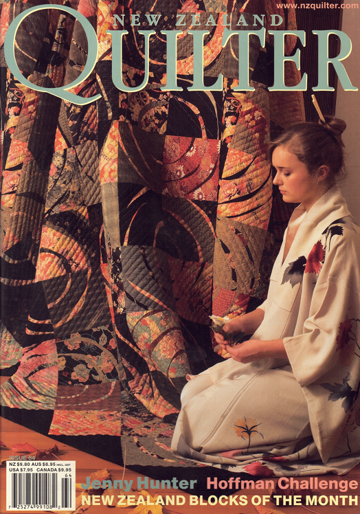 Magazine cover featuring a woman with a quilt and text about New Zealand Quilter.