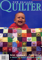 Magazine cover featuring a baby holding a colorful quilt with New Zealand Quilter branding.