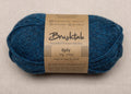 Close-up of bright blue yarn with a tweedy texture