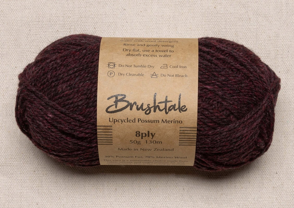 Close-up of dark rusty red yarn with a tweedy texture