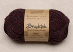Close-up of dark rusty red yarn with a tweedy texture