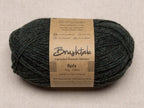 Close-up of dark forest green yarn with a tweedy texture