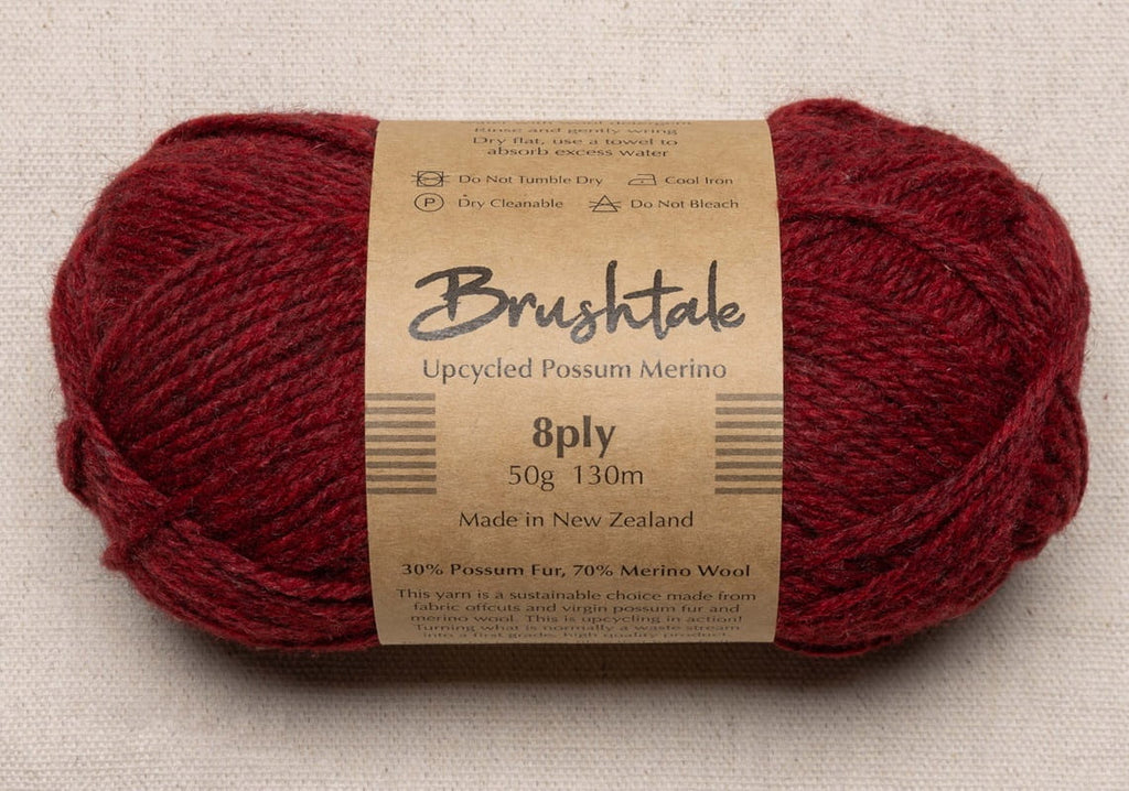 Close-up of red yarn with a tweedy texture