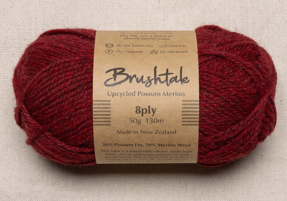 Close-up of red yarn with a tweedy texture