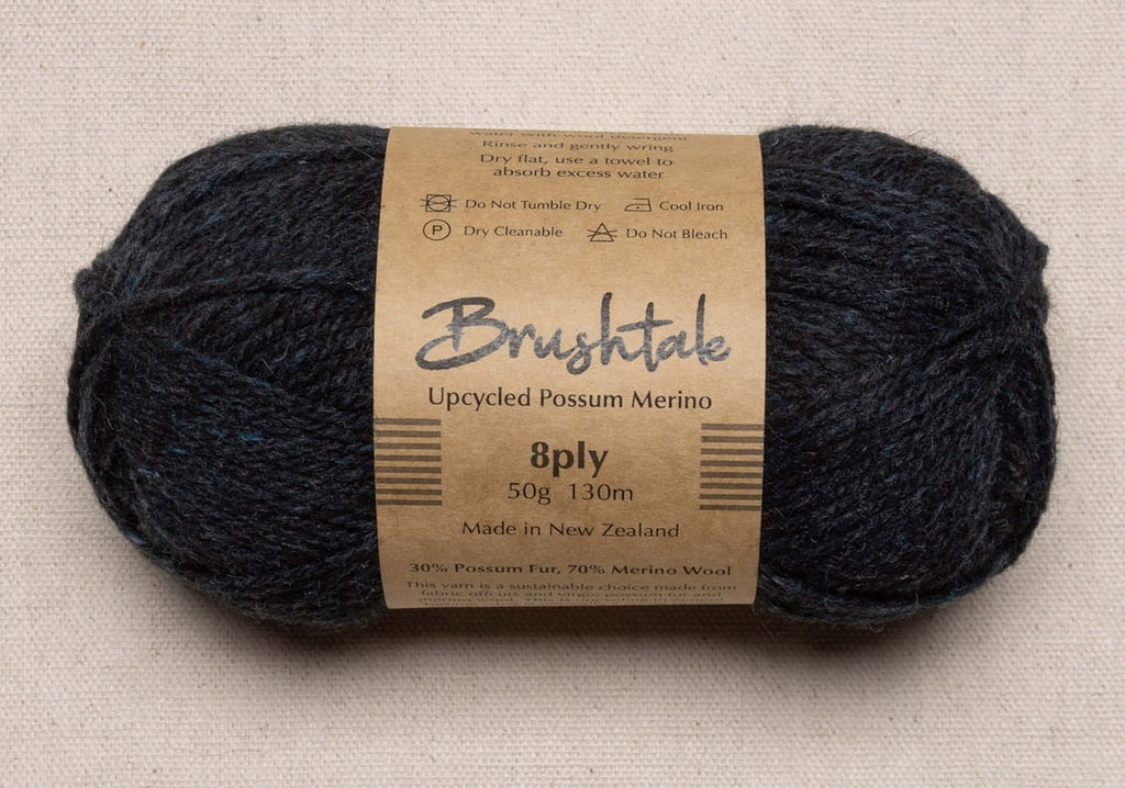 Close-up of dark rusty red yarn with a tweedy texture