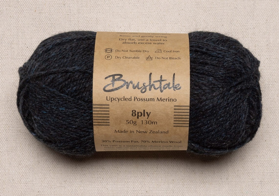 Close-up of dark rusty red yarn with a tweedy texture