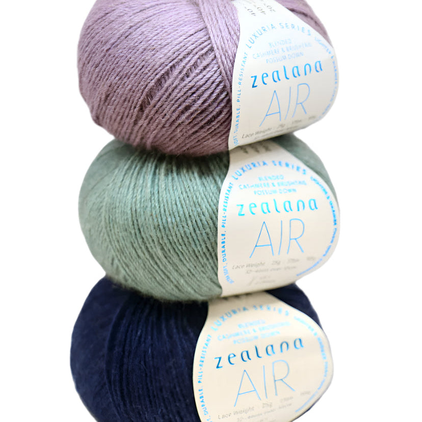 Three balls of yarn stacked on a white background with 'zealana AIR' labels.