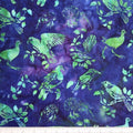 New Zealand designed quilt fabric with birds and floral elements on a textured background of turquoise blue and green