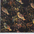 New Zealand designed quilt fabric with Tui birds and floral elements on a textured background in beige yellow and purple on black