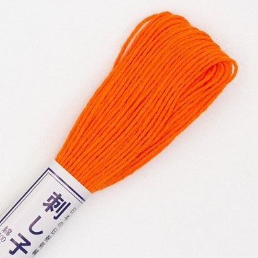 Skein of Olympus Sashiko Thread in colour bright orange on a white backgound