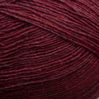 Close-up of a ball of dark cherry red yarn with a textured pattern