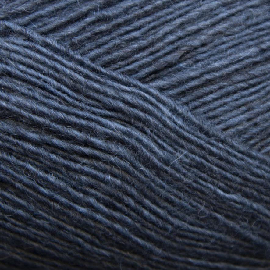 Close-up of a ball of ocean blue  yarn with a textured pattern