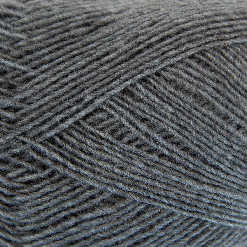 Close-up of a ball of mediuim slate blue yarn with a textured pattern