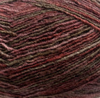 Close-up of a ball of yarn with brown and burgundy tones and a textured pattern