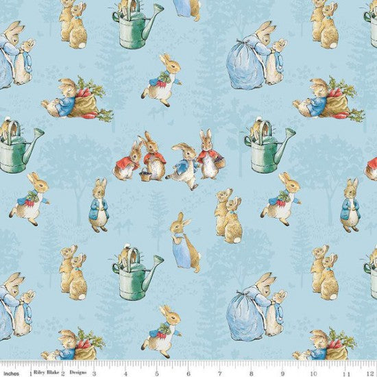 Quilt Fabric featuring a design with illustrations of Peter Rabbit and other rabbits in a garden setting on a blue background.