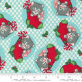 A fabric from the Kitty Christmas collection by Urban Chiks, featuring a design of gray cats in red Christmas stockings with decorative elements and a polka dot background.
