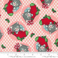 A fabric from the Kitty Christmas collection by Urban Chiks, featuring a design of cartoon kittens in red Christmas stockings on a pink background, with a ruler for scale.