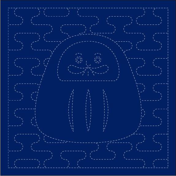 A pre-printed cotton fabric panel featuring a doll design in white on an indigo blue background, intended for Sashiko stitching.