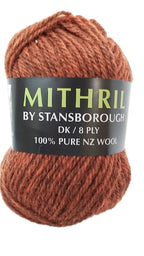Ball of rust yarn with a label reading 'Mithril by Stansborough' on a white background