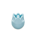 Close up of Blue tulip-shaped knitting needle point protector on a white background