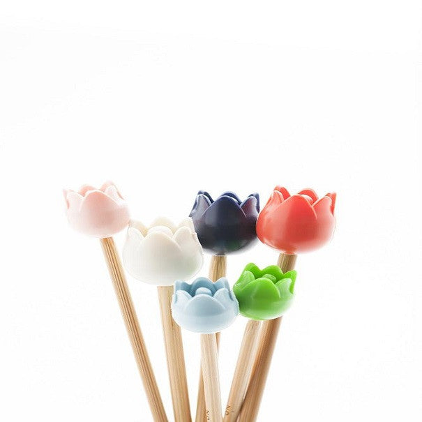 Colorful tulip-shaped point protectors on bamboo knitting needles 