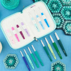 Set of Knitpro Waves crochet hooks in a case with crocheted samples on a blue background