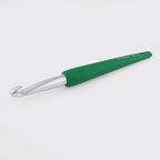 Dark green crochet hook on a white background
