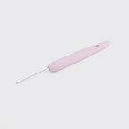 Pink crochet hook on a light gray background