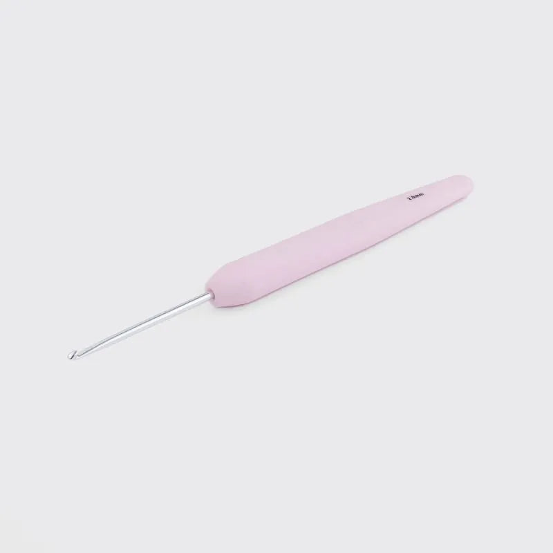Pink crochet hook on a light gray background
