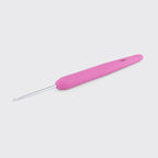 Pink crochet hook on a light gray background