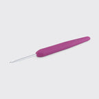 Magenta crochet hook on a light gray background