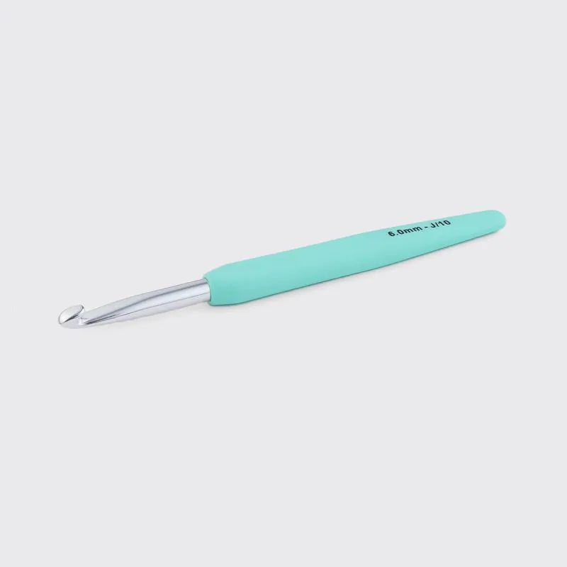 Turquoise crochet hook on a light gray background