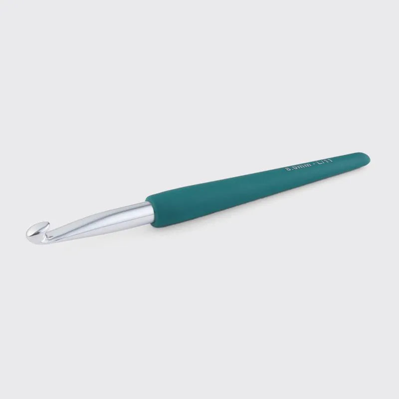 Emerald crochet hook on a white background