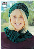 A woman wearing a green chunky knit hat and cowl, with the product label 'Heirloom 416' visible.