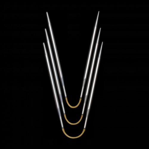 A set of three ADDI crazy trio knitting needles arranged in a V-shape on a black background.