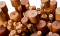A collection of ChiaoGoo wooden straight knitting needles in various sizes, with natural color wood finish.