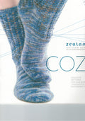 A book cover of Zealana Cozi featuring a close-up of a person wearing blue striped socks, with the title and 'Exclusive for our Artesian Senses Seekers' text.