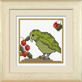 Cross-stitch kit depicting a colorful ground owl, known as Kakapo, within a New Zealand bush-themed pattern.