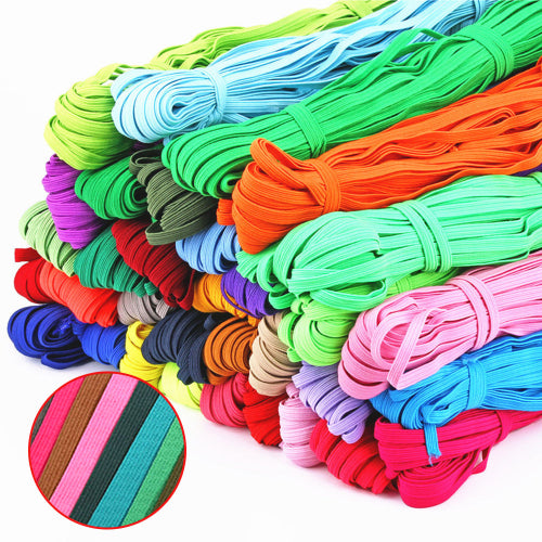 A collection of colorful elastic bands in various colors including black, blue, green, orange, pink, red, and yellow.