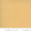 A yardstick measuring fabric width, with the mustard-colored quilting fabric labeled with 'moda' brand.