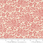 A yardstick measuring the width of a piece of Quilting fabric featuring a floral design with red flowers on a off-white background.