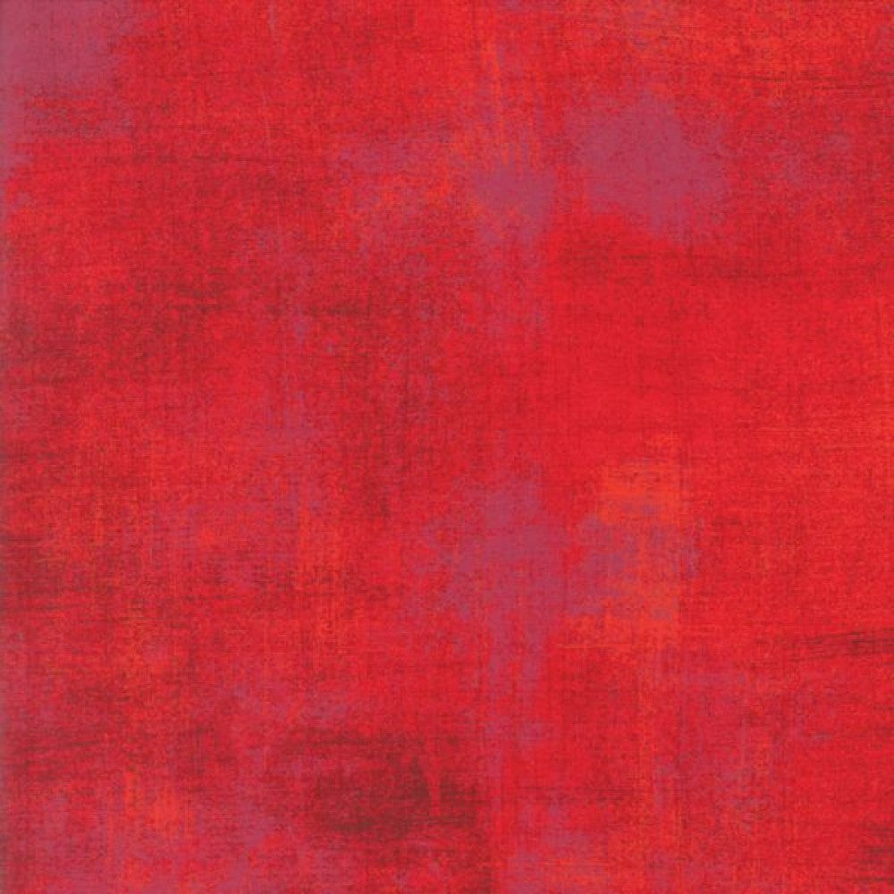A swatch of textured-effect red blender quilting fabric.
