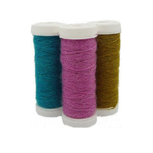 Three spools of sock reinforement yarn in teal, pink, and brown colors, arranged side by side.