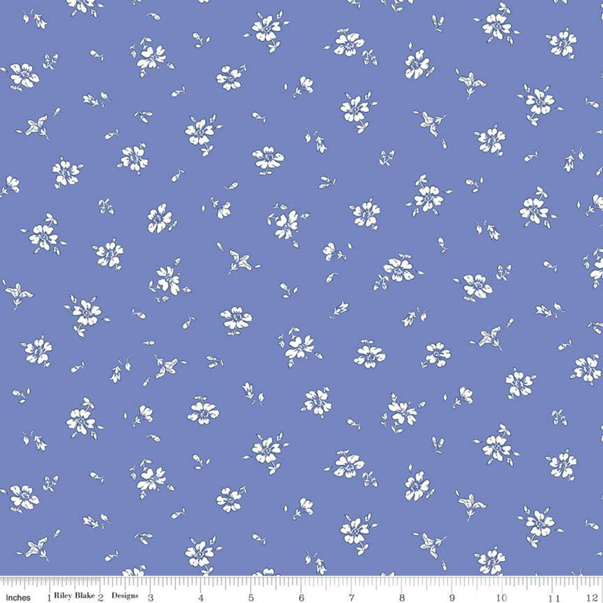 A blue cotton quilting fabric with a floral design designed by Liberty Fabrics.