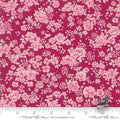 A yardstick measuring fabric with a floral Quilt Fabric consisting of pink roses on a red background.