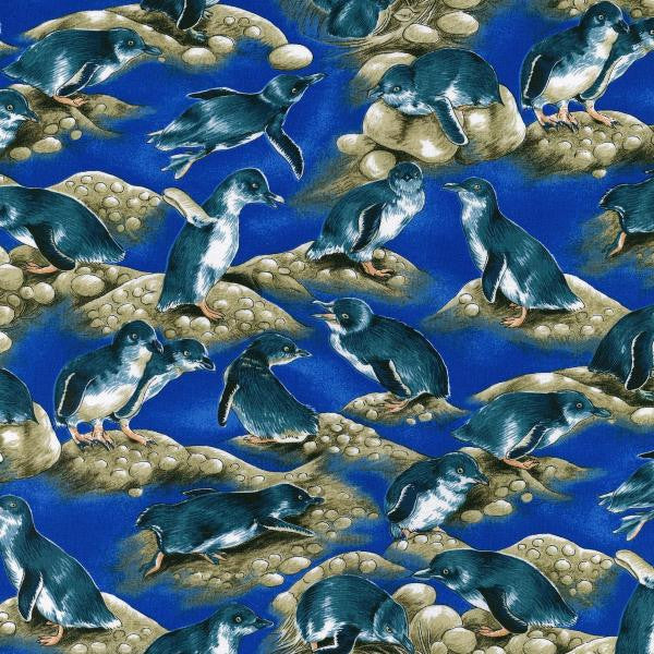 A quilt fabric featuring a print of New Zealand's native Little Blue Penguins in various poses on a blue background.