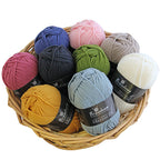 A basket containing multiple skeins of New Zealand merino yarn in various solid colors.